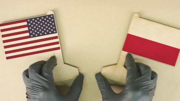 Flags of the USA and Poland made of recycled paper on the cardboard table — Stock Video