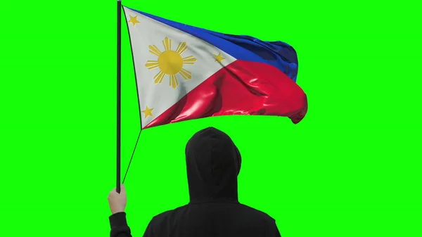 Bendera Filipina dan pria tak dikenal, terisolasi dengan latar belakang hijau — Stok Foto