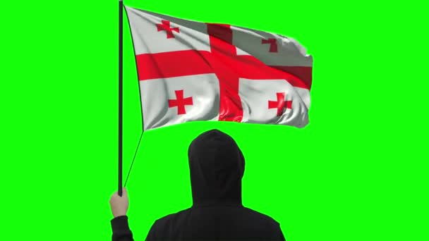 Flagge von Georgien schwenkend und unbekannter Mann trägt schwarz, alpha-matt — Stockvideo