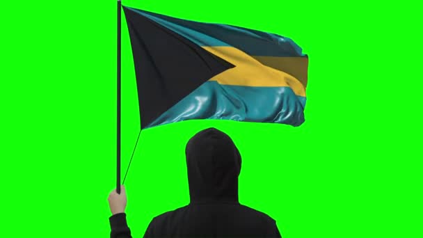 Hombre desconocido sostiene bandera de Bahamas, alfa mate — Vídeo de stock