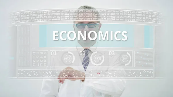 ECONOMICS szöveg egy modern érintőképernyős kijelzőn és egy fehér köpenyt viselő férfi tudós — Stock Fotó