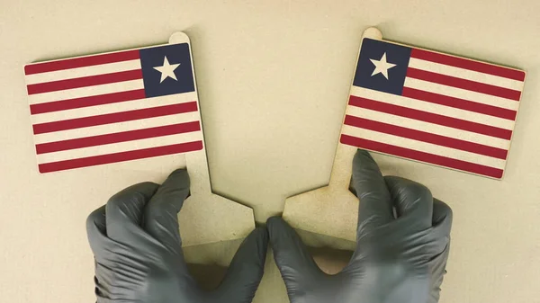Два прапори Ліберії, зроблені з картону на столі. — стокове фото