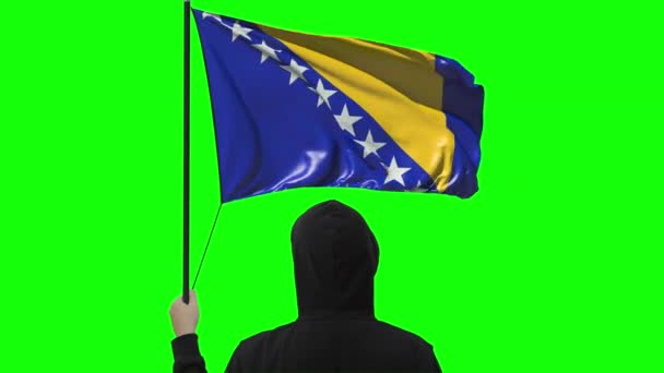 Waving flag of Bosnia and Herzegovina and unknown man wearing black, alpha matte — Stock Video