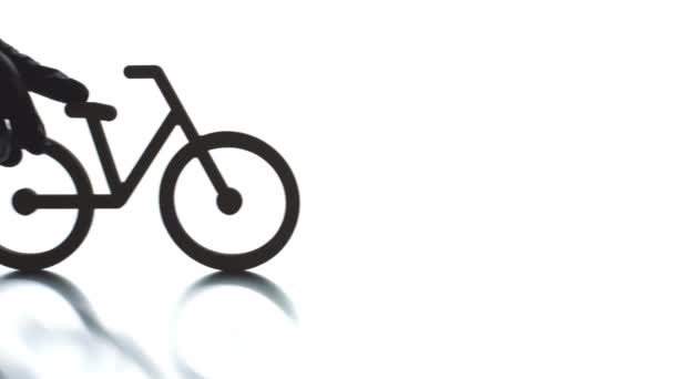 Putting bicycle black icon on light background. Transportation concept — Stock Video