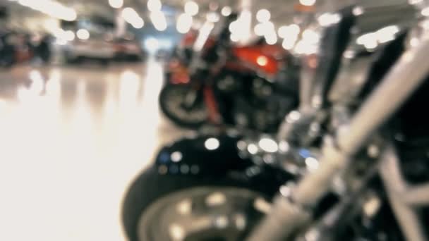 Blurred polished motorcycles in a dealership showroom — Stock Video