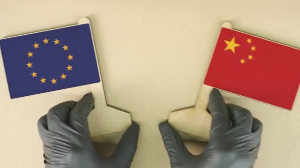 Vlajky Evropské unie a Číny vyrobené z recyklovaného papíru na lepenkovém stole — Stock video