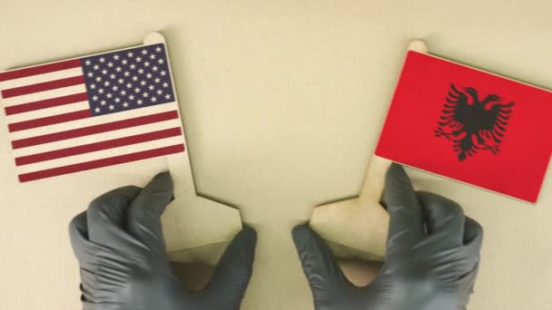 Flagi USA i Albanii wykonane z papieru z recyklingu na stole kartonowym — Wideo stockowe