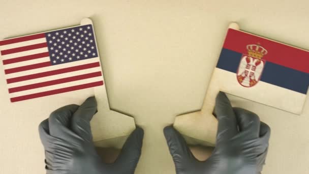 Flags of the USA and Serbia made of cardboard on the desk — Stock Video