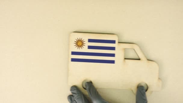 Flag of Uruguay on the recycled cardboad truck icon, national sustainable logistics concept — Stock Video