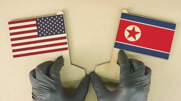 Banderas de los Estados Unidos y Corea del Norte de cartón sobre el escritorio —  Fotos de Stock