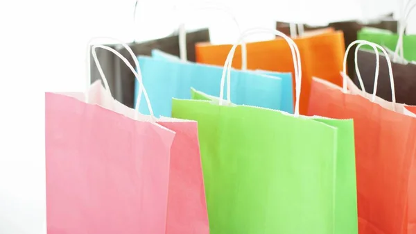 Colorful paper bags with purchases or presents, black friday or seasonal sale concept — Fotografia de Stock