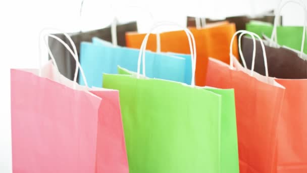 Colorful paper bags with purchases or presents, black friday or seasonal sale concept — Wideo stockowe