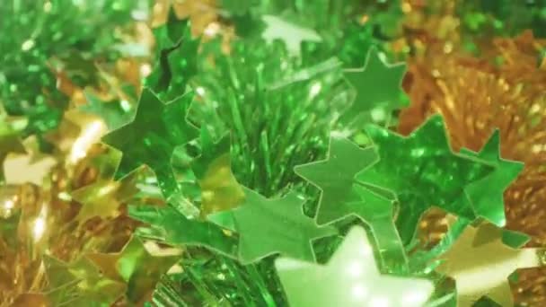 Golden and green tinsel holiday garlands macro dolly shot — Stock Video