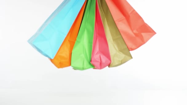 Hand puts many color shopping bags on the table — Wideo stockowe