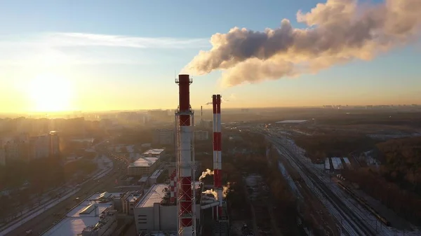 Tiro aéreo de pilhas de fumaça industrial vermelho e branco no fundo do pôr do sol. Moscou, Rússia — Fotografia de Stock