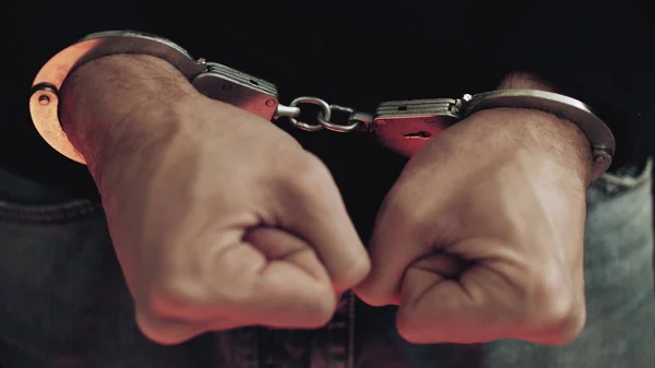 Criminal in handcuffs with police strobe lights close-up — Stock Photo, Image