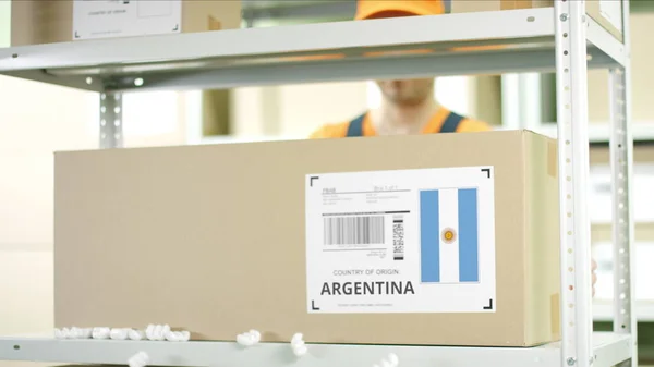 Caja de cartón de Argentina y trabajador de almacén —  Fotos de Stock