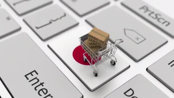 Cajas con texto MADE IN JAPAN y carrito de compras en el teclado. Conceptual looping 3d animación — Vídeo de stock