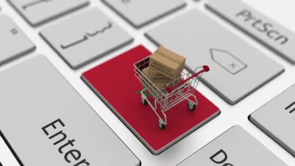 Cartons with MADE IN MOROCCO text and shopping cart on the computer keyboard. Conceptual looping 3d animation — Stock Video