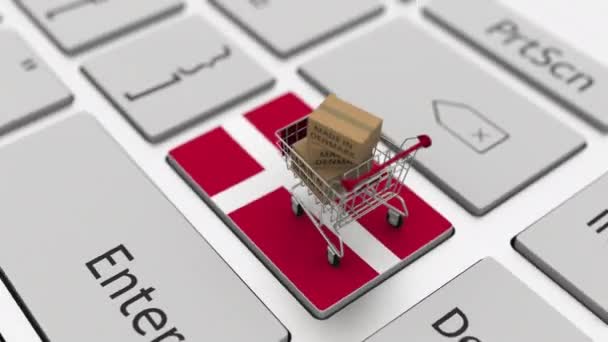 Goods made in Denmark in the shopping cart on the keyboard. Export or import concepts, looping 3d animation — Stock Video