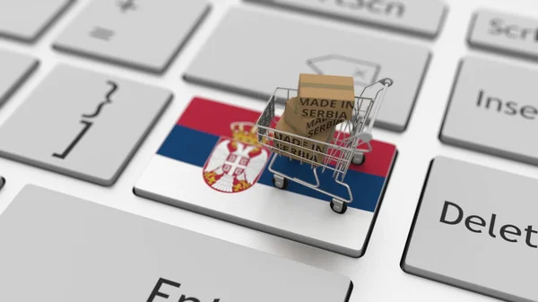 Barang yang dibuat di Serbia dalam keranjang belanja di keyboard. Ekspor atau impor konsep, render 3d — Stok Foto