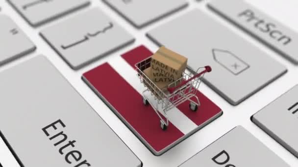 Boxes with MADE IN LATVIA text and shopping cart on the keyboard. Conceptual looping 3d animation — Stock Video