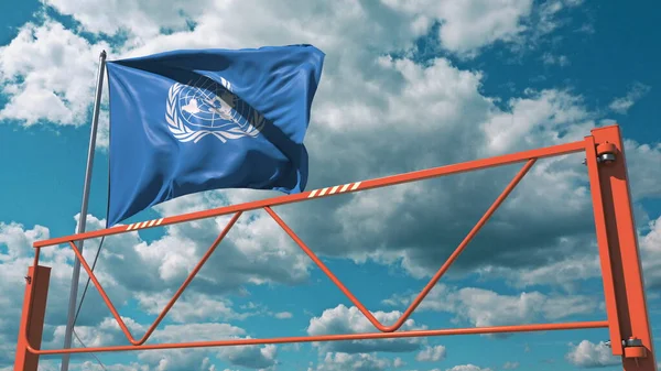 Vegsperre med svingarm og De forente nasjoners flagg, redaksjonelt forbud i forbindelse med gjengivelse av 3d – stockfoto