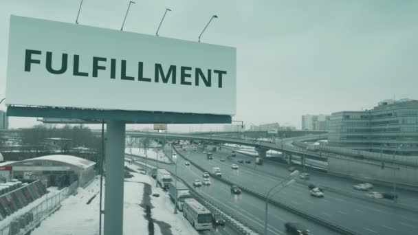 Vista aérea de una valla publicitaria con texto FULFILLMENT en carretera urbana en invierno — Vídeos de Stock