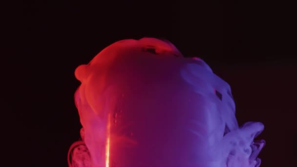 Red and blue smoking cold dry ice or frozen carbon dioxide in a glass of water, slow motion shot — Stock Video