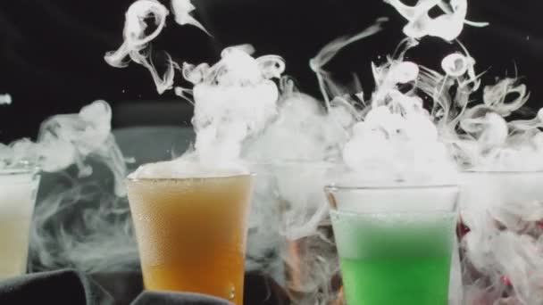 Colorful cocktails with smoking dry ice or frozen carbon dioxide slow motion shot — Stock Video