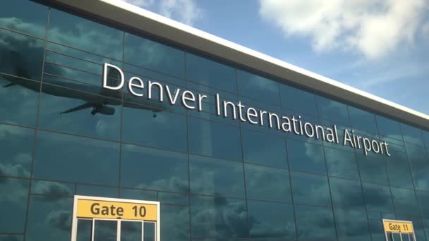 Landing airplane reflects in the modern windows with Denver International Airport text — Stock Video