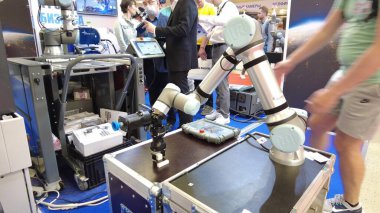 MOSCOW, RUSSIA - MAY 26, 2021. Universal Robots collaborative robot arm in action clipart