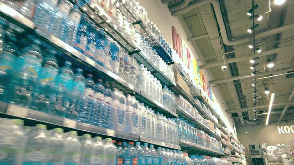 Garrafas de plástico de água nas prateleiras de um supermercado — Fotografia de Stock