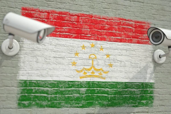 タジキスタンの国旗のついたCCTVカメラと壁。監視関連3Dレンダリング — ストック写真
