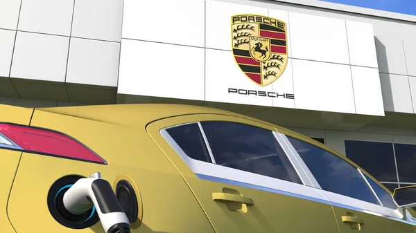 Cargando enchufe eléctrico del coche y logotipo de PORSCHE. Editorial conceptual 3d 3d rendering — Foto de Stock