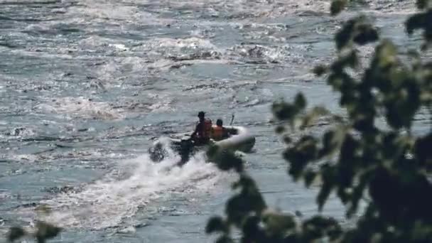 Unknown inflatable motor boat moves along rumbling whitewater river, tele shot — Stock Video