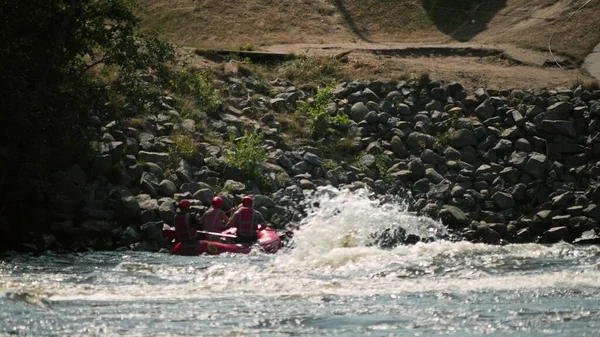 Neznámí lidé trénují rafting na nafukovací vor na dunivé řece — Stock fotografie