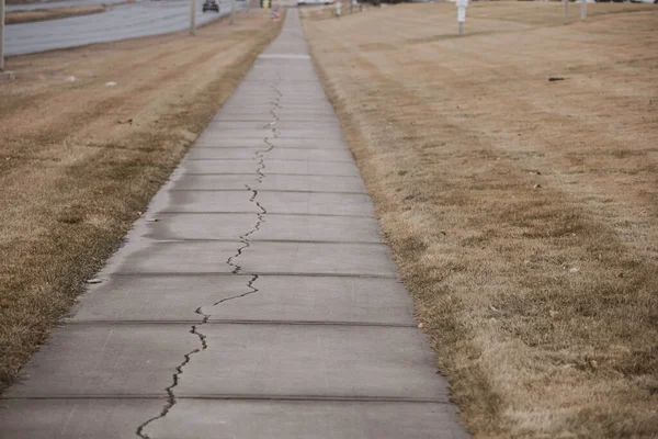 Concrete footpath pavement cracked split down the middle — Photo