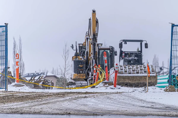 İnşaat ekipmanları tel örgülerin arkasında.