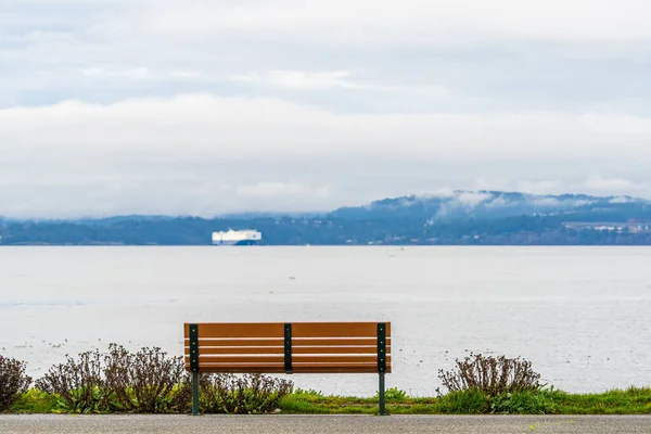 Gemi ile sahil parkındaki park bankında.