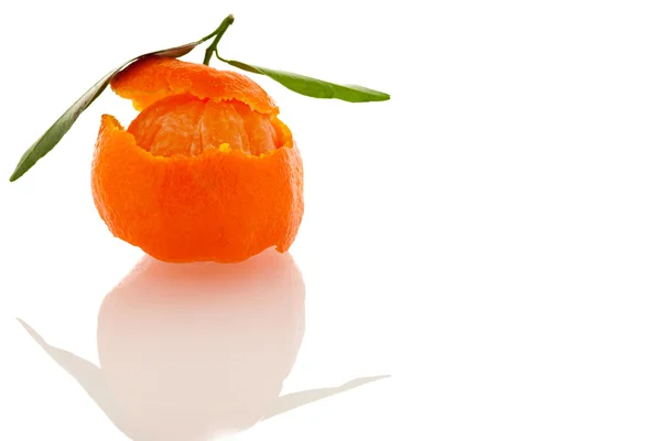 Spiral peel of orange mandarin with green leafs and a slice of c — Stock Photo, Image