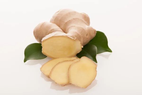 Ginger root with green leaves isolated over white. — Stock Photo, Image