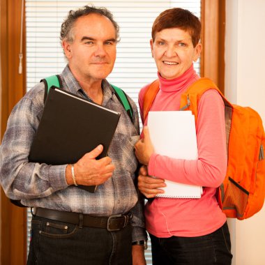 Older couple representing lifelong learning. Couple with school  clipart