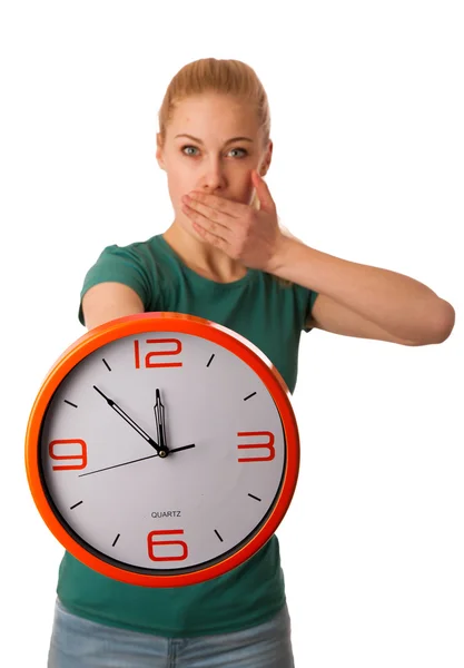 Blonde woman holding big clock in hand isolated over white. — Stock Photo, Image