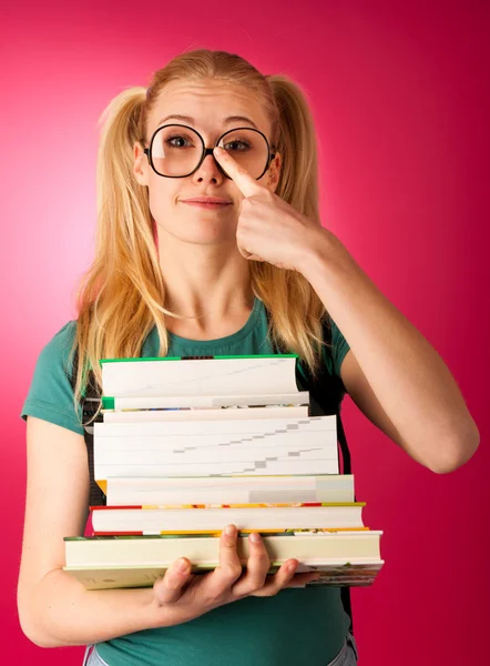 Curious, naughty, playful schoolgirl with stack of books and big — Stock Photo, Image