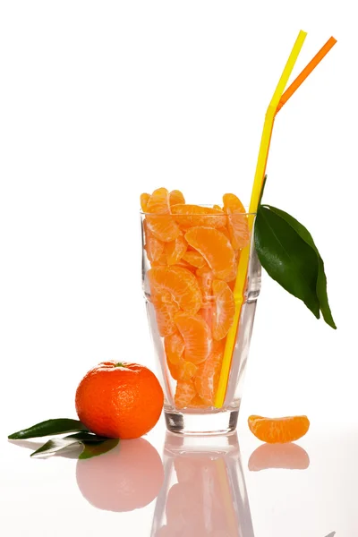 Big glass filled with orange mandarin citrus fruit slices, decor — Stock Photo, Image