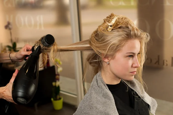 Professional hair stylist at work - hairdresser  doing hairstyle — Stock Photo, Image