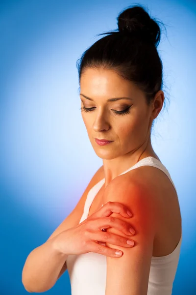 Beautiful woman having pain in her shoulder - injury — Stock Photo, Image