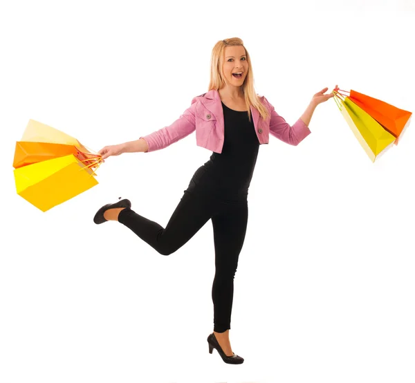 Carino donna bionda con shopping borse vivaci isolato su bianco — Foto Stock