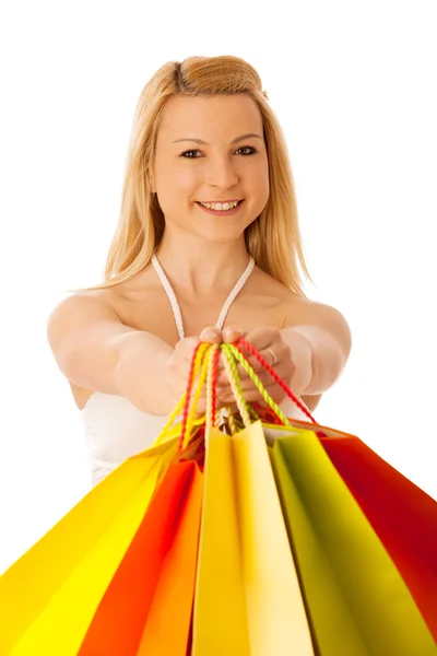 Cute blonde woman with shopping vibrant bags isolated over white — Stock Photo, Image